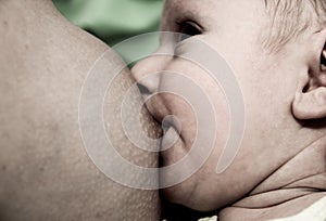 Young mother breastfeeding her baby boy