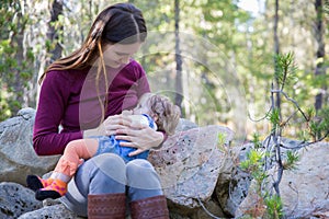 Young mother breastfeeding her baby outdoors