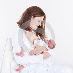 Young mother breastfeeding her newborn baby