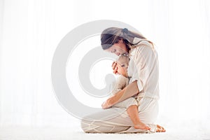 Young mother breastfeeding her toddler baby boy