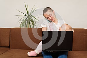 Young mother business woman, holding baby working and talking on phone