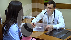 A young mother with a child to the doctor.