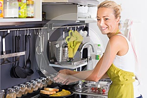 Young Mother Cooking at Home.