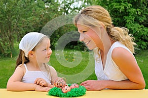 Young mother and daughter having Easter time