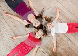 Young mother and daughter lying on the floor