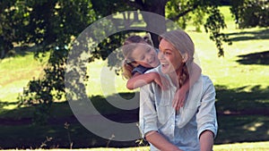 Young mother and daughter relaxing in the park together