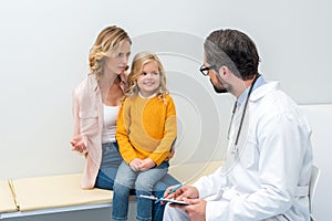 young mother and daughter visiting pediatrist