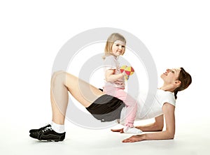 Young mother doing sport exercises with daughter