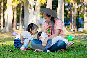 Young mother feeding her baby in the park