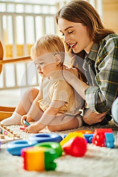 A young mother happily engages with