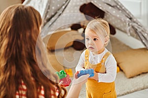 A young mother happily engages with