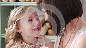 Young mother having fun with her daughter, Mom talking with her daughter