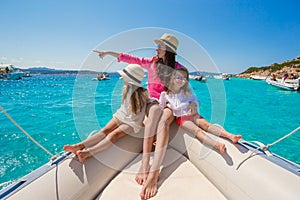 Young mother with her adorable baby girls resting