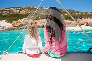 Young mother with her adorable daughter resting on