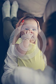 Young mother with her baby girl at home.