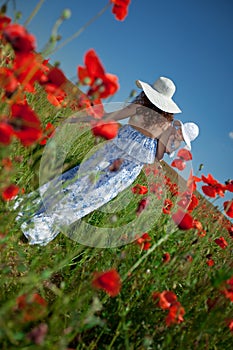 Young mother and her baby-girl in poppy field