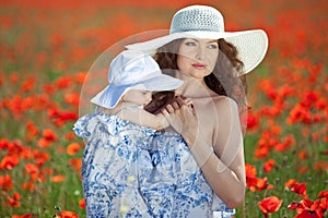 Young mother and her baby-girl in poppy field