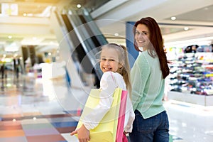 Young mother and her daughter doing shopping together