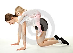 Young mother and her daughter doing sport