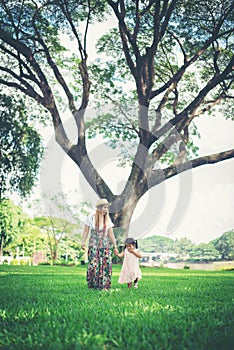 Young mother and her little daughter walking