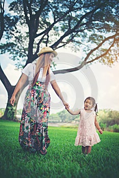 Young mother and her little daughter walking