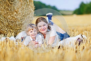 Young mother and her little son having fun at picnicking photo