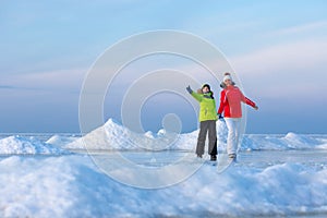 Young mother and her son on icy beach