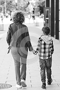 Young mother and her son walking at city. Family, lifestyle and relationship