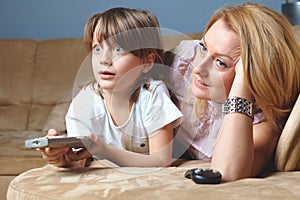 Young mother with her son watch tv photo