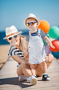 Young mother and her young son on the beach.