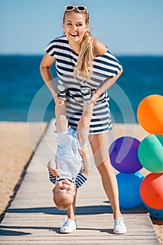 Young mother and her young son on the beach