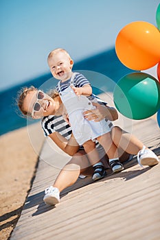 Young mother and her young son on the beach