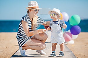 Young mother and her young son on the beach