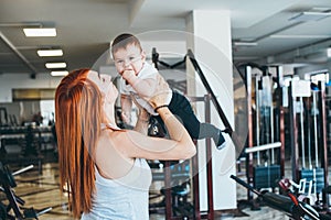 Young mother with her young son in the gym