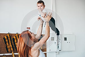 Young mother with her young son in the gym