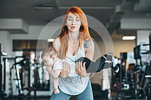 Young mother with her young son in the gym
