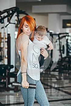 Young mother with her young son in the gym