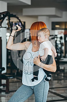 Young mother with her young son in the gym