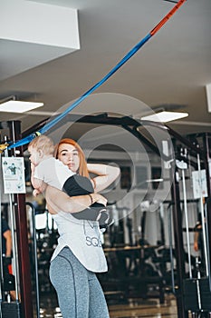 Young mother with her young son in the gym