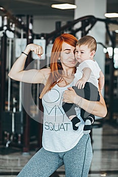 Young mother with her young son in the gym