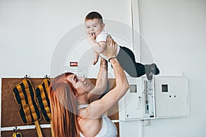 Young mother with her young son in the gym