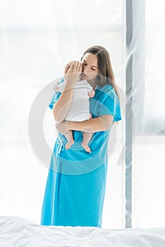 Young mother holding her child in hospital