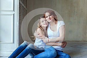 Mother and daughter near the windiow photo