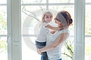 Mother and daughter near the windiow photo