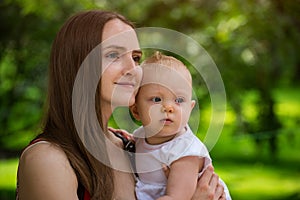 Young mother holding her cute baby. Happy Family. Lovely mom and child girl