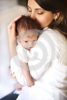 Young mother holding her newborn child