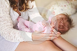 Young mother holding her newborn child.