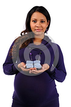 Young Mother Holding Knitted Baby Shoes