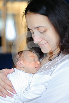 Young mother holding newborn baby.