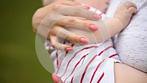 Young mother, holding tenderly her baby boy, close portrait